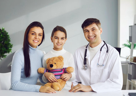 doctor and mother with daughter smiling