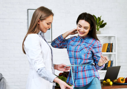 doctor checking the weight of the woman