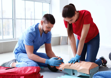 man and woman doing practice for cpr