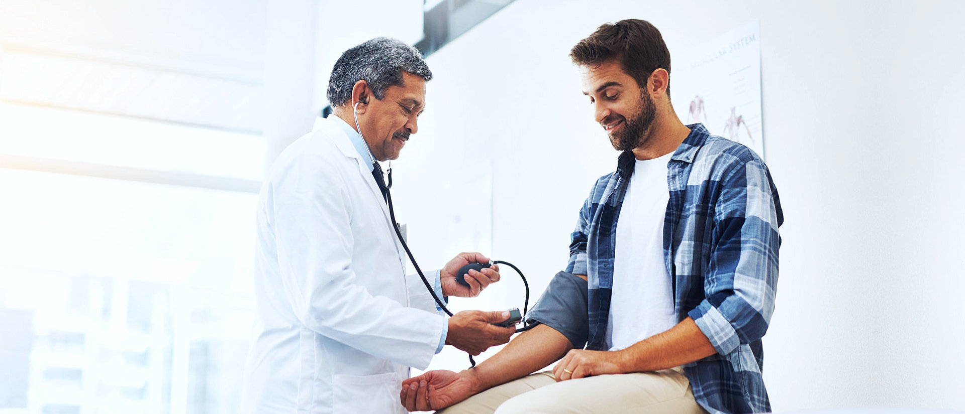 doctor checking the man blood pressure