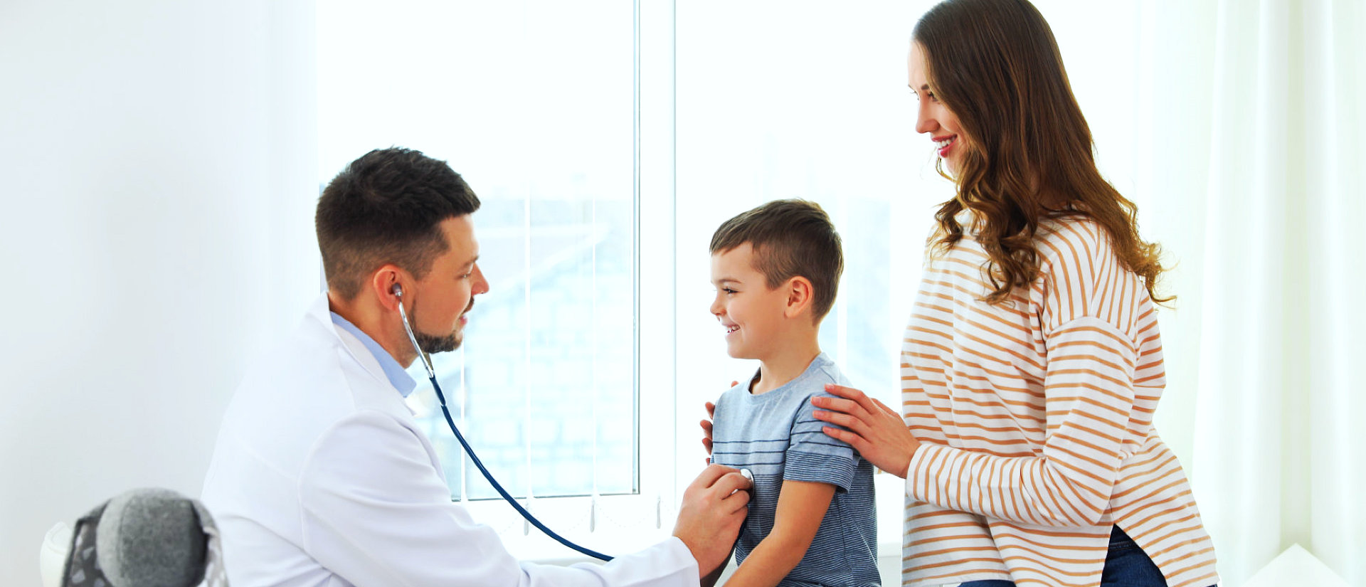 child smiling while getting check up